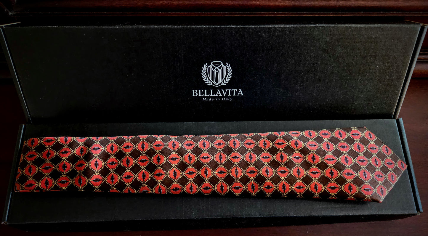 A Bellavita necktie with a red and black geometric pattern, presented inside its black branded gift box on a dark wooden surface.