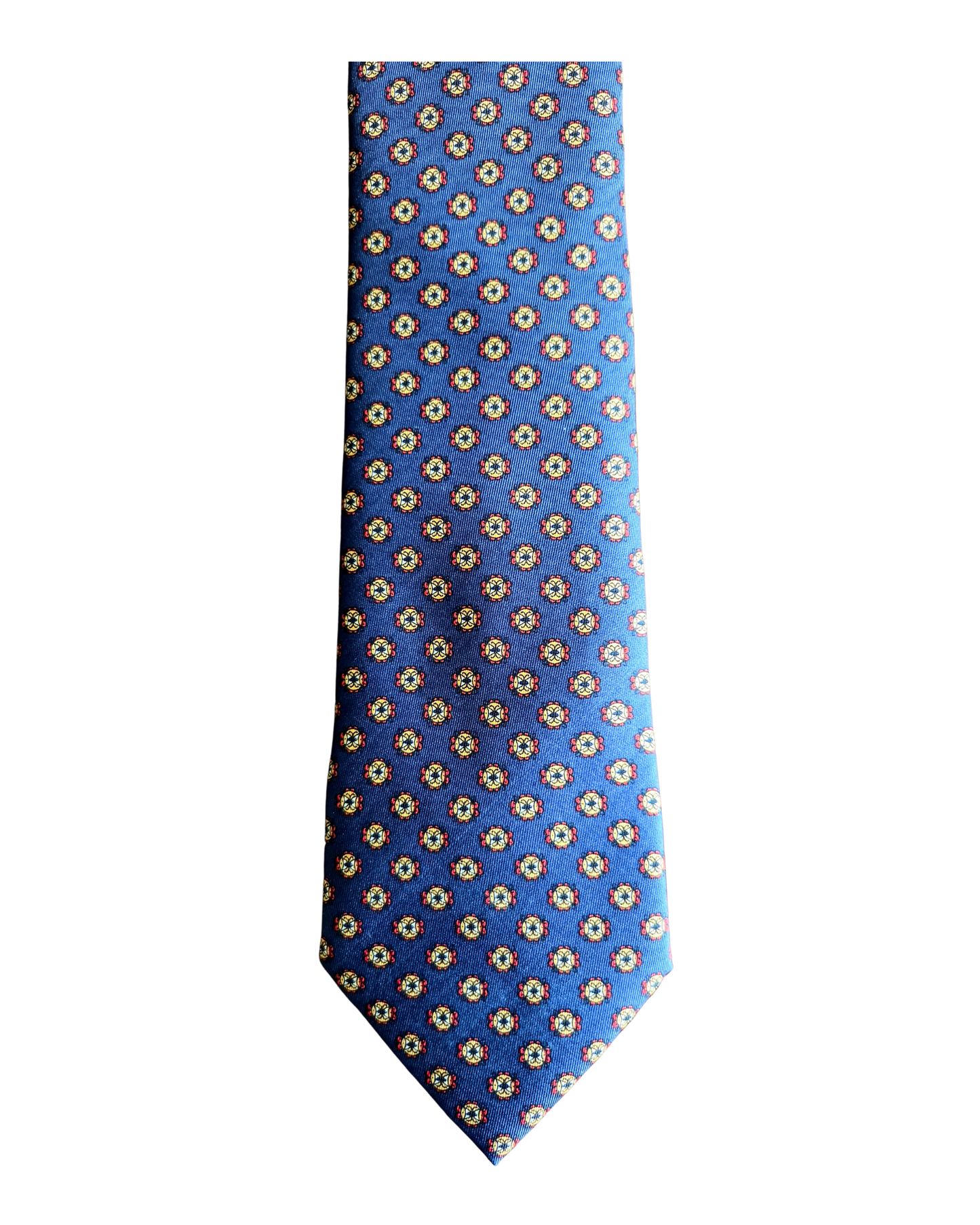 A blue necktie with a repeating geometric pattern of small white and yellow diamond motifs, shown flat against a plain white background.