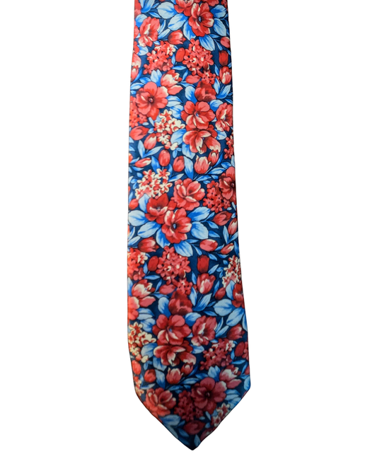 A necktie with a dense floral print featuring red and orange flowers, blue leaves, and a dark blue background, shown against a plain white background.