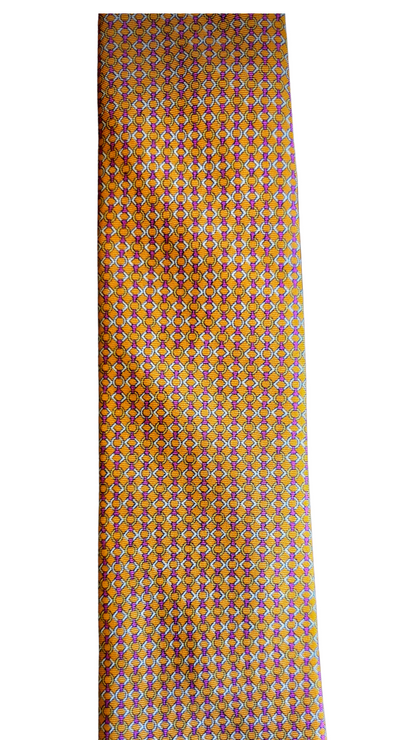 A slim necktie with a dense geometric pattern in orange, yellow, and blue, displayed vertically against a plain white background.